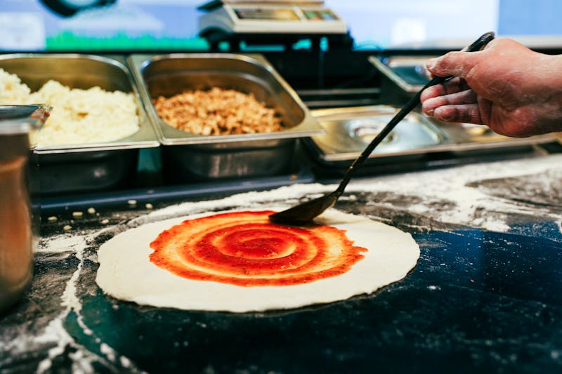 Pizza Ranch team preparing ranch pizza in a warm, inviting restaurant kitchen